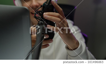 Game streamer using pc setup playing multiplayer first person shooter 101496863