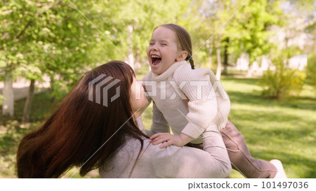 happy family. mom hugs child girl daughter park. cheerful girl spinning her mother arms. happy child. child dream mom. kid laughs his mother arms park. happy family concept. child runs green grass happy family. mom hugs child girl daughter park. cheerful girl spinning her mother arms. happy child. child dream mom. kid laughs his mother arms park. happy family concept. child runs green grass 101497036