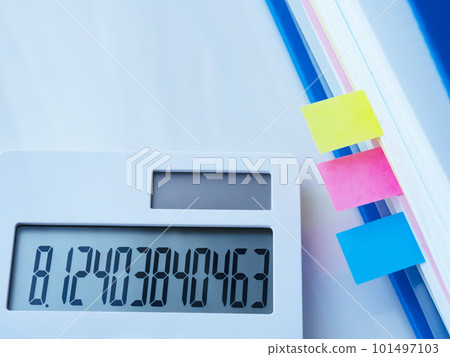 A blue file and a calculator on the desk A blue file and a calculator on the desk 101497103