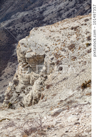Goats are resting in the rocks on the mountainside. 101497357