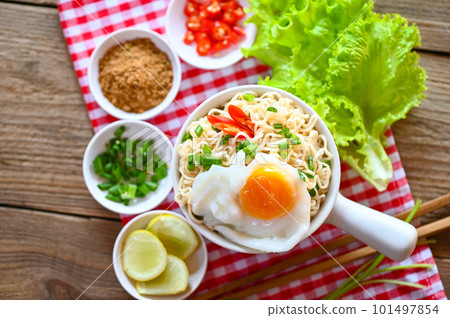 noodles bowl with boiled egg minced pork vegetable spring onion lemon lime lettuce celery and chili on table food, noodle soup instant noodles cooking tasty eating with plate 101497854