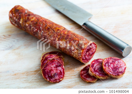 Appetizing salchichon sausage on wooden table 101498004
