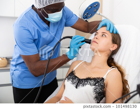 Female receiving hardware facial mesotherapy at cosmetology clinic Female receiving hardware facial mesotherapy at cosmetology clinic 101498130