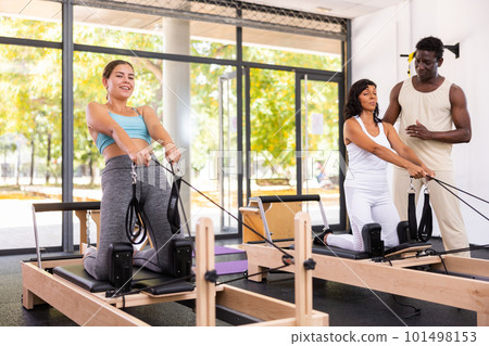 Positive woman and African American man training with female instructor Positive woman and African American man training with female instructor 101498153