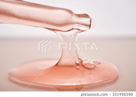 Pipette with a viscous pink cosmetic close-up. 101498390