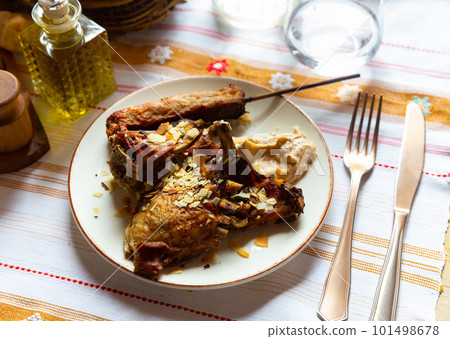Baked lamb with kebab on wooden skewer and yogurt dip 101498678