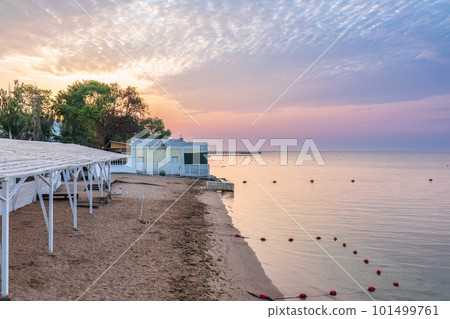 Tranquil Beach Sunrise. Closeup sea sand beach. Beautiful panoramic landscape, colorful golden sunrise over calm sea with waves 101499761