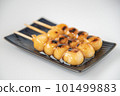 Delicious mitarashi dango on an indigo plate 101499883