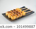 Delicious mitarashi dango on an indigo plate 101499887