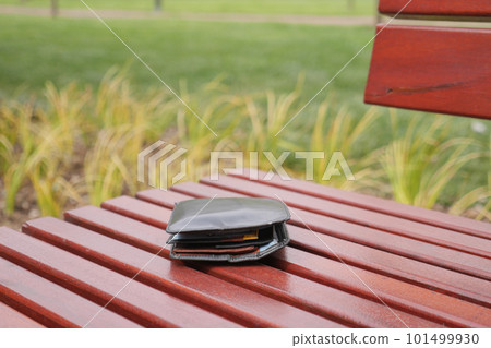 left wallet on a bench in the park left wallet on a bench in the park 101499930