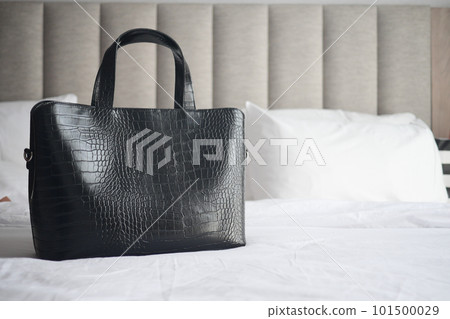 women purse wallet on bed, close up. 101500029