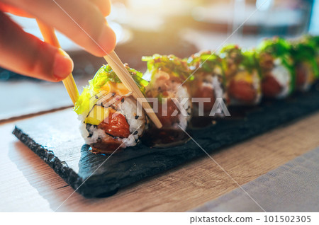Close up of tasty japanese uramaki sushi with salmon Close up of tasty japanese uramaki sushi with salmon 101502305
