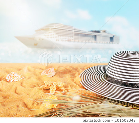 Female hat on a golden sand at the tropical beach 101502342