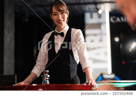 Female dealer and male customer in casino Female dealer and male customer in casino 101502408
