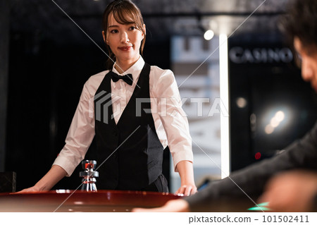 Female dealer and male customer in casino Female dealer and male customer in casino 101502411