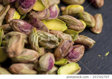 Crispy delicious pistachios with salt on the table Crispy delicious pistachios with salt on the table 101502707