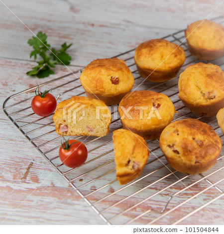 Savory muffin with ham and cheese on blue background Savory muffin with ham and cheese on blue background 101504844
