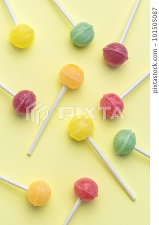 Sweet lollipops on yellow background 101505087