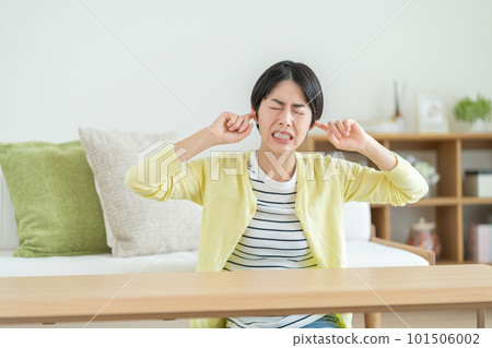Woman suffering from tinnitus Woman suffering from noise Woman having anxiety Woman thinking about something 101506002