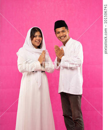 man and woman with salam in Muslim clothes with pink man and woman with salam in Muslim clothes with pink 101506741