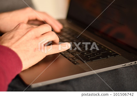 Hands typing on the keyboard of a notebook Hands typing on the keyboard of a notebook 101506742