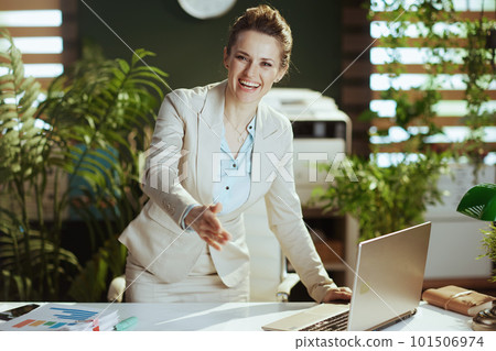 happy business woman in green office giving hand for handshake 101506974