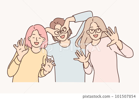 Happy girls of friend have fun making funny faces and putting fingers to faces instead of glasses 101507854