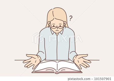 Surprised religious woman sitting at table with open bible reading holy book with christian prayers 101507901