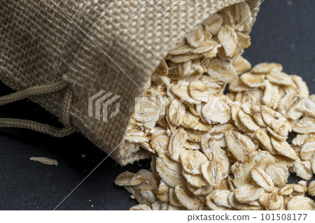 Oat flakes poured into a linen cloth bag Oat flakes poured into a linen cloth bag 101508177