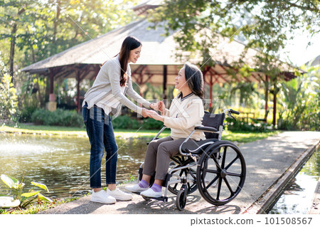 Happy family, Elderly grandmother in wheelchair with daughter smiling Happy family, Elderly grandmother in wheelchair with daughter smiling 101508567