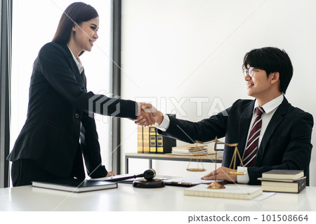 Male lawyer shaking hands with client after discussing deal of a Male lawyer shaking hands with client after discussing deal of a 101508664