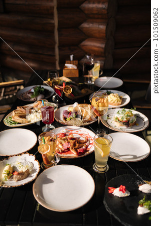 Served table with food and drinks. Restaurant on terrace.  101509062