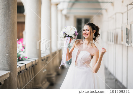 Bride holding big and beautiful wedding bouquet with flowers 101509251