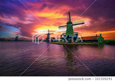 Dramatic sunset above farm houses and windmills of Zaanse Schans, Netherlands Dramatic sunset above farm houses and windmills of Zaanse Schans, Netherlands 101509291