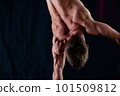 circus artist keeps balance on one hand isolated on a black background. concept of handstand and calisthenic 101509812