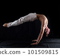flexible circus artist keep balance on hands on a black background. concept of contortion and flexibility  101509815