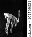 circus artist keeps balance on one hand isolated on a black background. concept of handstand and calisthenic 101509821