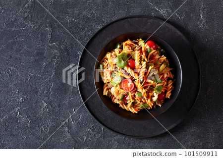 pasta salad with ground beef and veggies in bowl 101509911