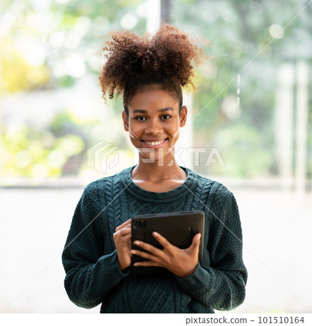African american student woman in sweater writing information an African american student woman in sweater writing information an 101510164