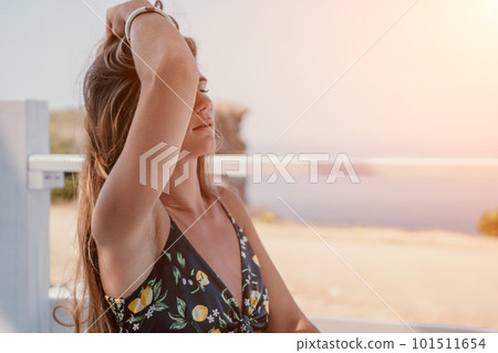 Happy woman portrait in cafe. Boho chic fashion style. Outdoor photo of young happy woman with long hair, sunny weather outdoors sitting in modern cafe. Happy woman portrait in cafe. Boho chic fashion style. Outdoor photo of young happy woman with long hair, sunny weather outdoors sitting in modern cafe. 101511654