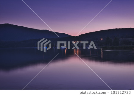 The water of the Tegernsee reflects the purple evening twilight near Gmund am Tegernsee, Bavaria, Germany The water of the Tegernsee reflects the purple evening twilight near Gmund am Tegernsee, Bavaria, Germany 101512723