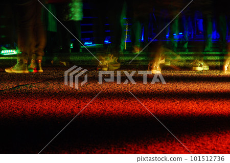 Long exposure shot of feet walking on an illuminated rainbow road in Essen, Germany 101512736
