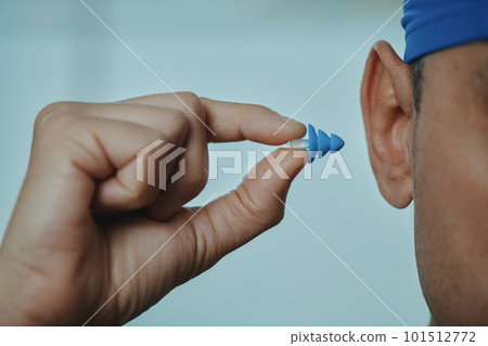 swimmer man about to put an earplug swimmer man about to put an earplug 101512772