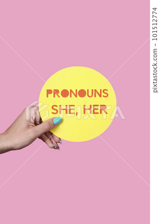 holds a sign with the text my pronouns are she, her holds a sign with the text my pronouns are she, her 101512774