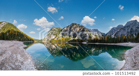 Autumn peaceful alpine lake Braies or Pragser Wildsee. Fanes-Sennes-Prags national park, South Tyrol, Dolomites Alps, Italy, Europe. Picturesque traveling, seasonal and nature beauty concept scene. Autumn peaceful alpine lake Braies or Pragser Wildsee. Fanes-Sennes-Prags national park, South Tyrol, Dolomites Alps, Italy, Europe. Picturesque traveling, seasonal and nature beauty concept scene. 101513492