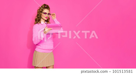 Portraif of young pretty student with blond hair wearing eyeglasses and pink stylish look over studio background. Banner with copy space for ad Portraif of young pretty student with blond hair wearing eyeglasses and pink stylish look over studio background. Banner with copy space for ad 101513581