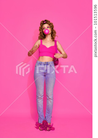Portrait of beautiful girl woman wearing stylish clothes with bubblegum standing over pink studio background. Girl like sweet lollipop Portrait of beautiful girl woman wearing stylish clothes with bubblegum standing over pink studio background. Girl like sweet lollipop 101513596
