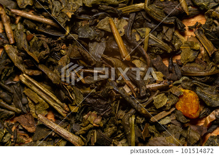 A mixture of dry green large-leaf tea with soursop. Background. 101514872