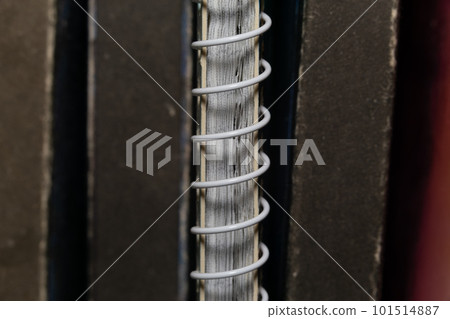 A spring-loaded notebook among old brown books 101514887