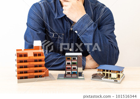 A man who worries in front of a house model 101516344